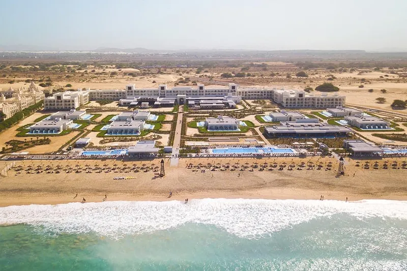 Pool terraces and white facades of Riu Palace Boavista, the all inclusive resort beside Praia das Dunas on Boa Vista, Cape Verde