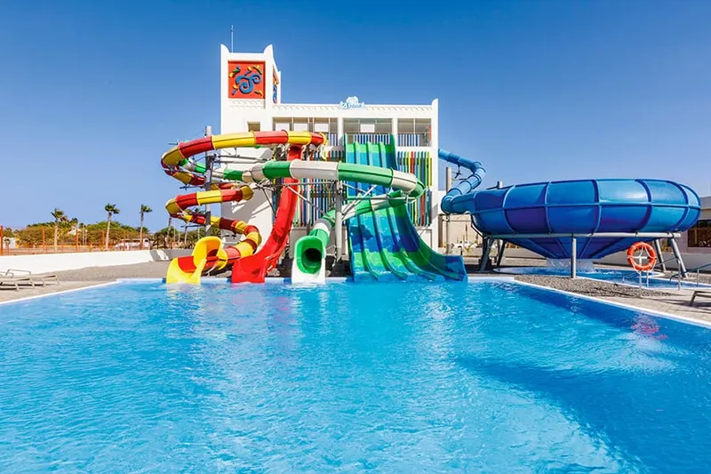 The limestone facade and beachfront pools of Hotel Riu Palace Santa Maria, a 5-star all inclusive resort on Sal, Cape Verde